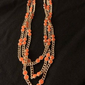 Gold tone 3 strand necklace with orange stones